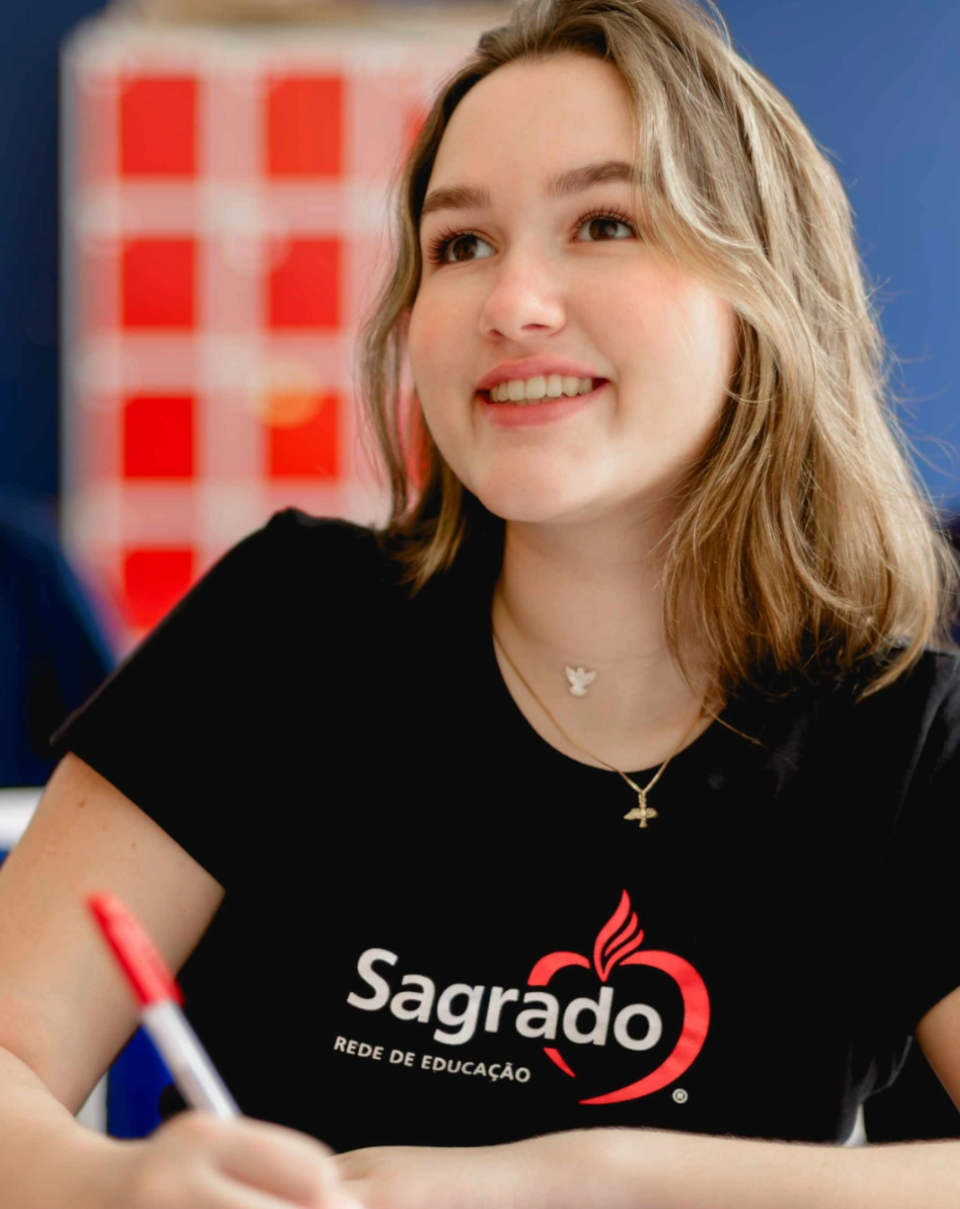 Estudante do Sagrado sorrindo durante uma atividade